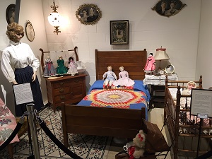 DOLLS AND APRONS EXHIBIT JUNE THROUGH JULY